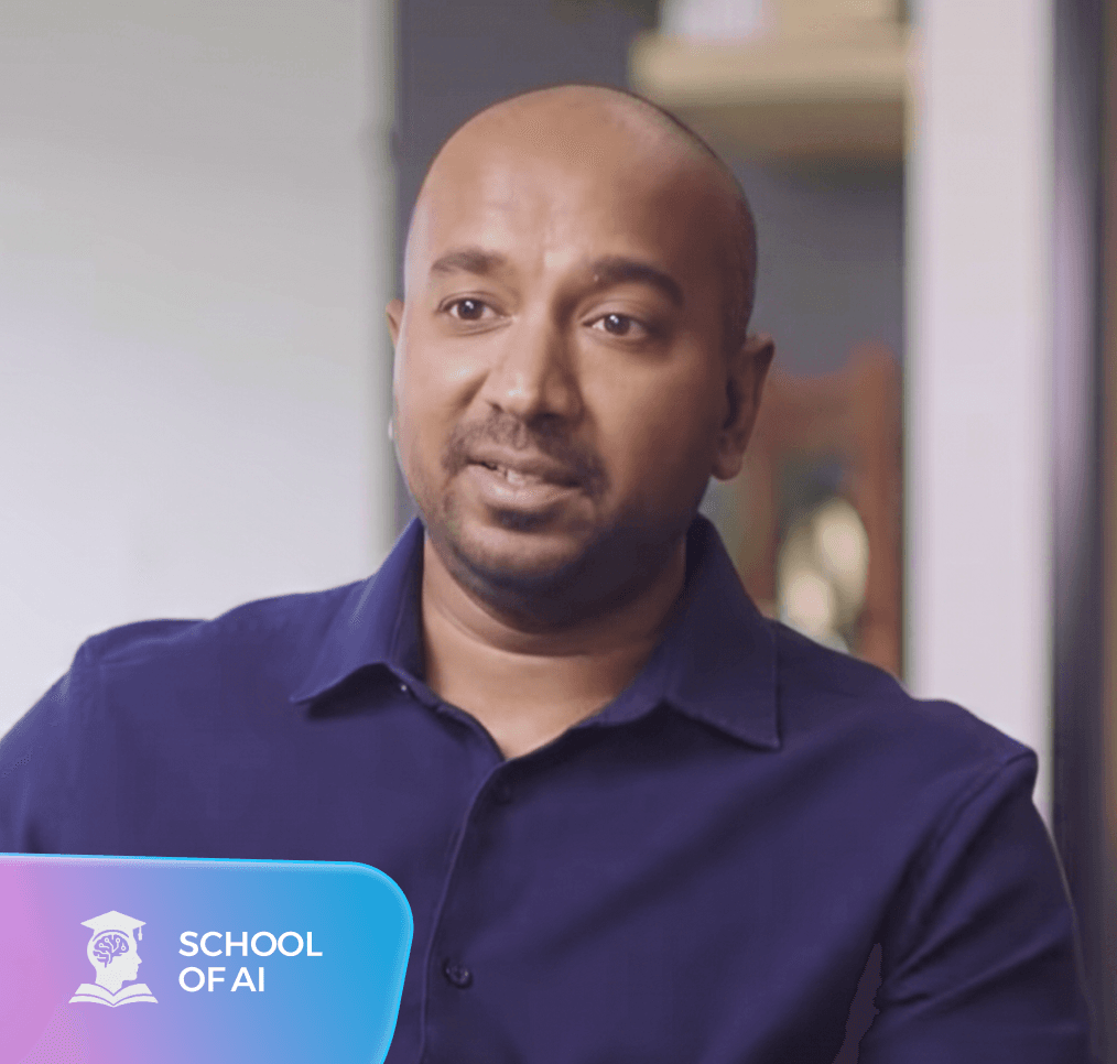 A man with a shaved head and beard wears a dark blue shirt. A "SCHOOL OF AI" logo is in the bottom left.