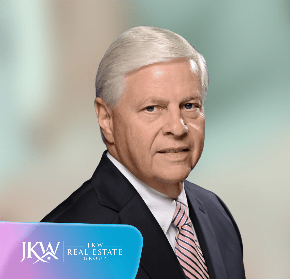Headshot of an older man in a suit and tie, with the JKW Real Estate Group logo.