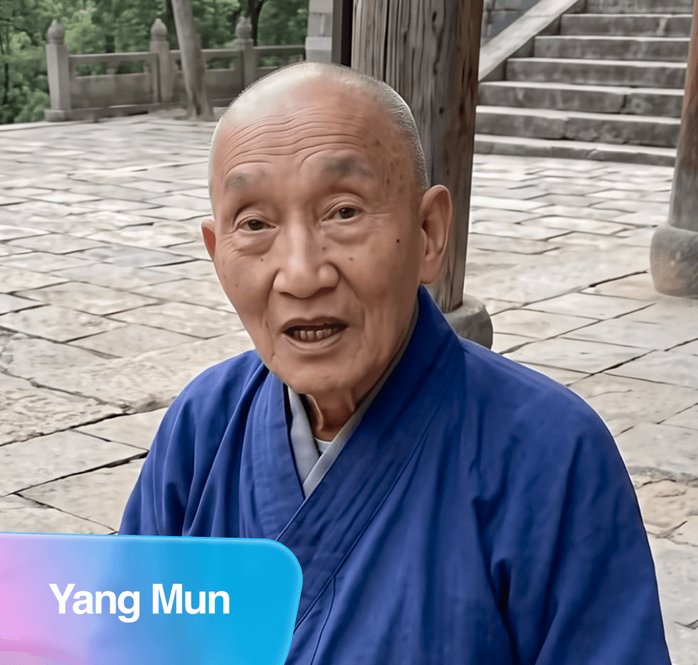 Yang Mun, an elderly bald person in a blue robe, speaking on a stone patio.