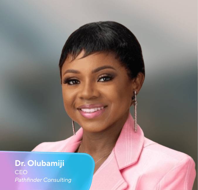 Headshot of Dr. Olubamiji, CEO of Pathfinder Consulting, smiling in a pink blazer.
